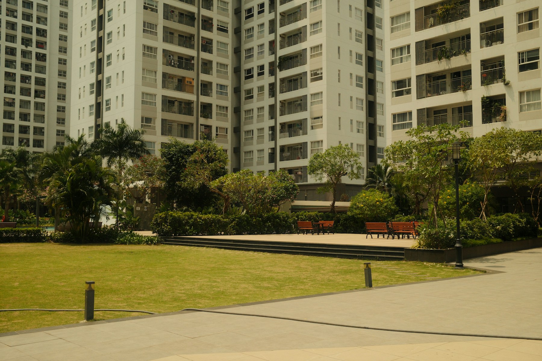 Calm residential courtyard with benches and green space